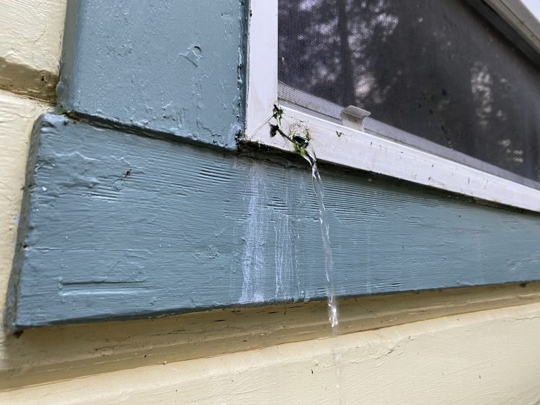 a window with water leaking out of it