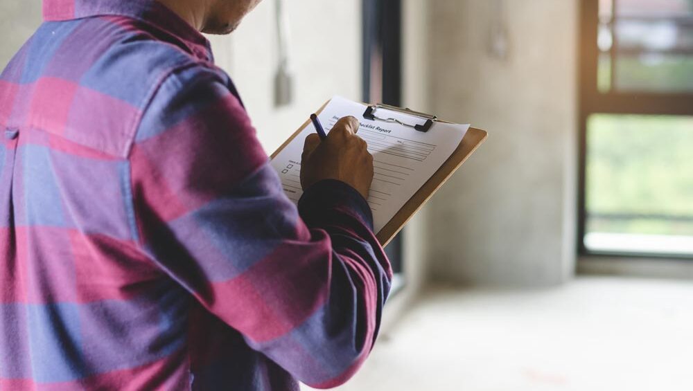 A home inspector with a clipboard