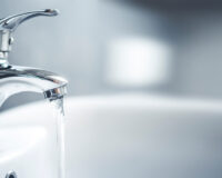 Water runs out of a faucet during a plumbing home inspection.