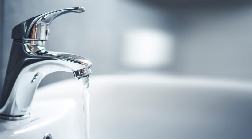 Water runs out of a faucet during a plumbing home inspection.